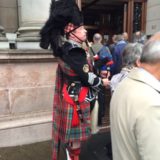 Traditioneller Bagpiper geleitet die Kongressteilnehmer in die City Chambers